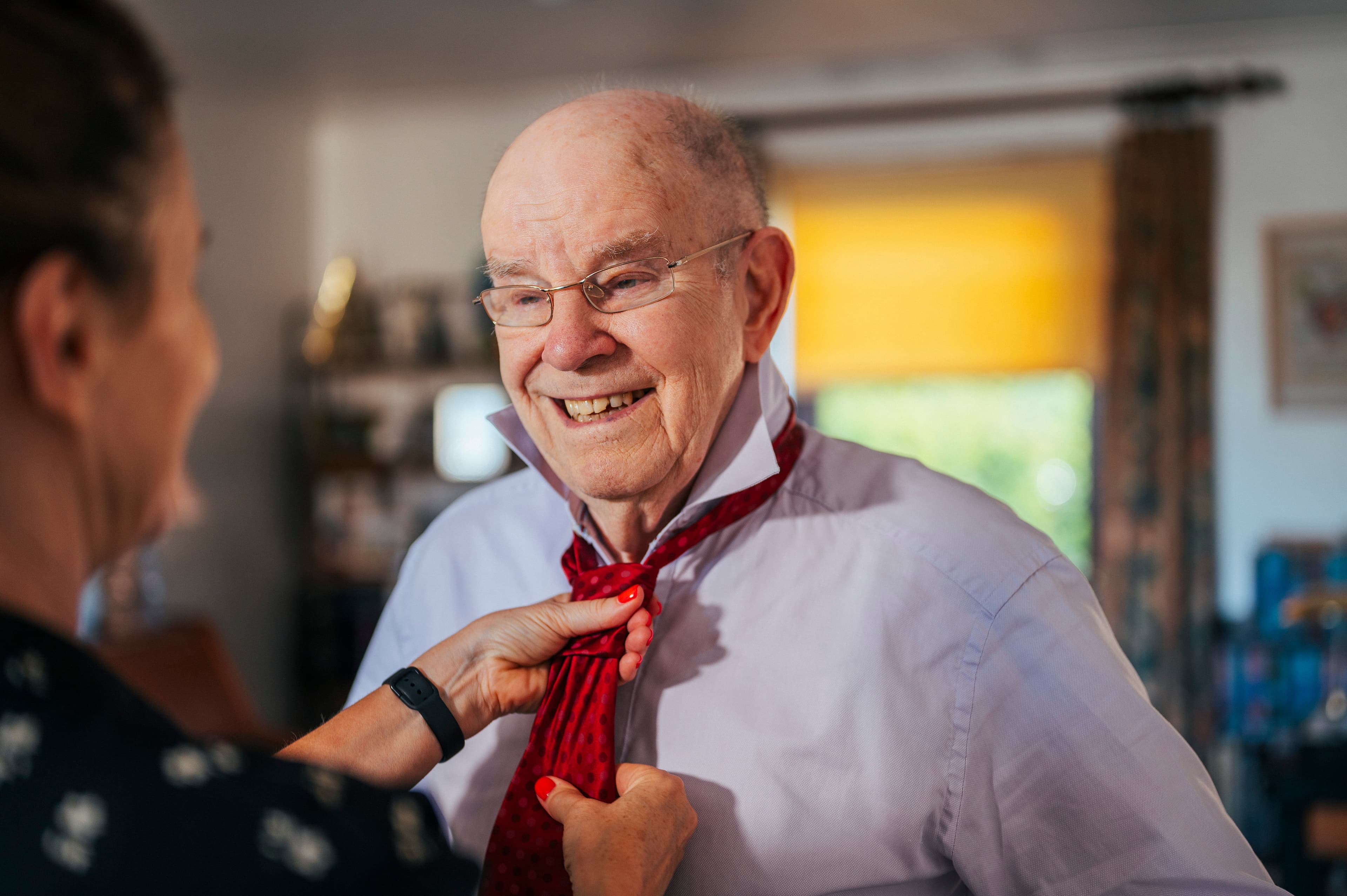 Compassionate Pavan Homecare caregiver assisting an elderly client at home