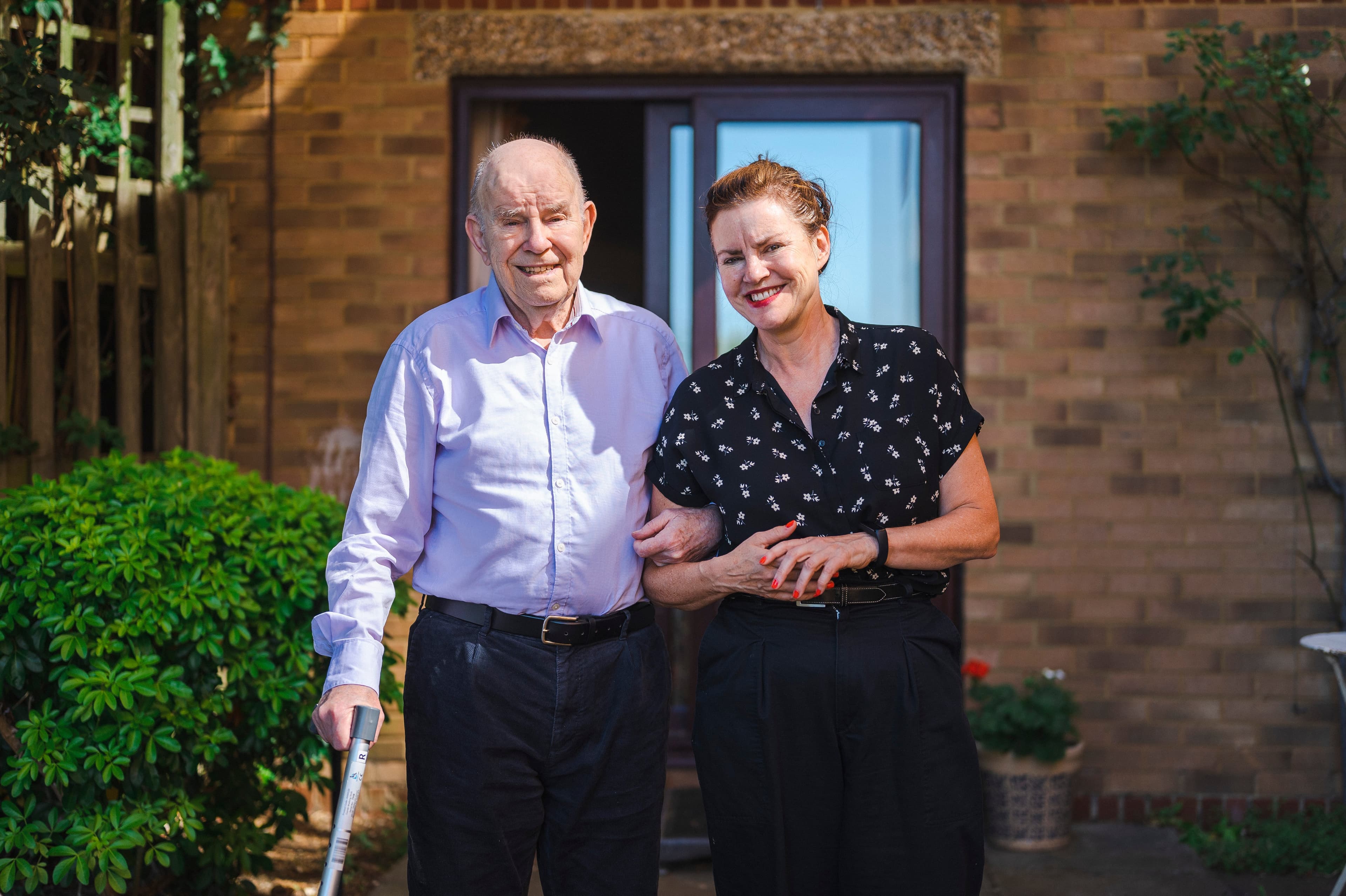 Caregiver helping senior client with comfort and care