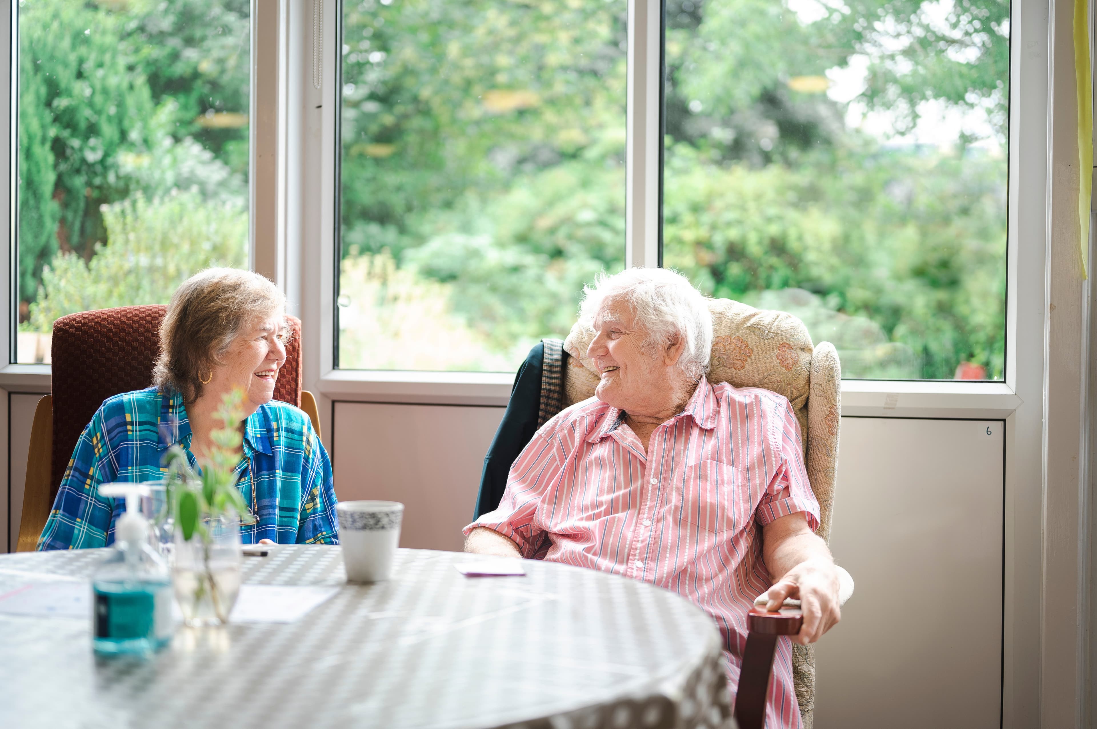 A caregiver assisting a senior client safely using a walker