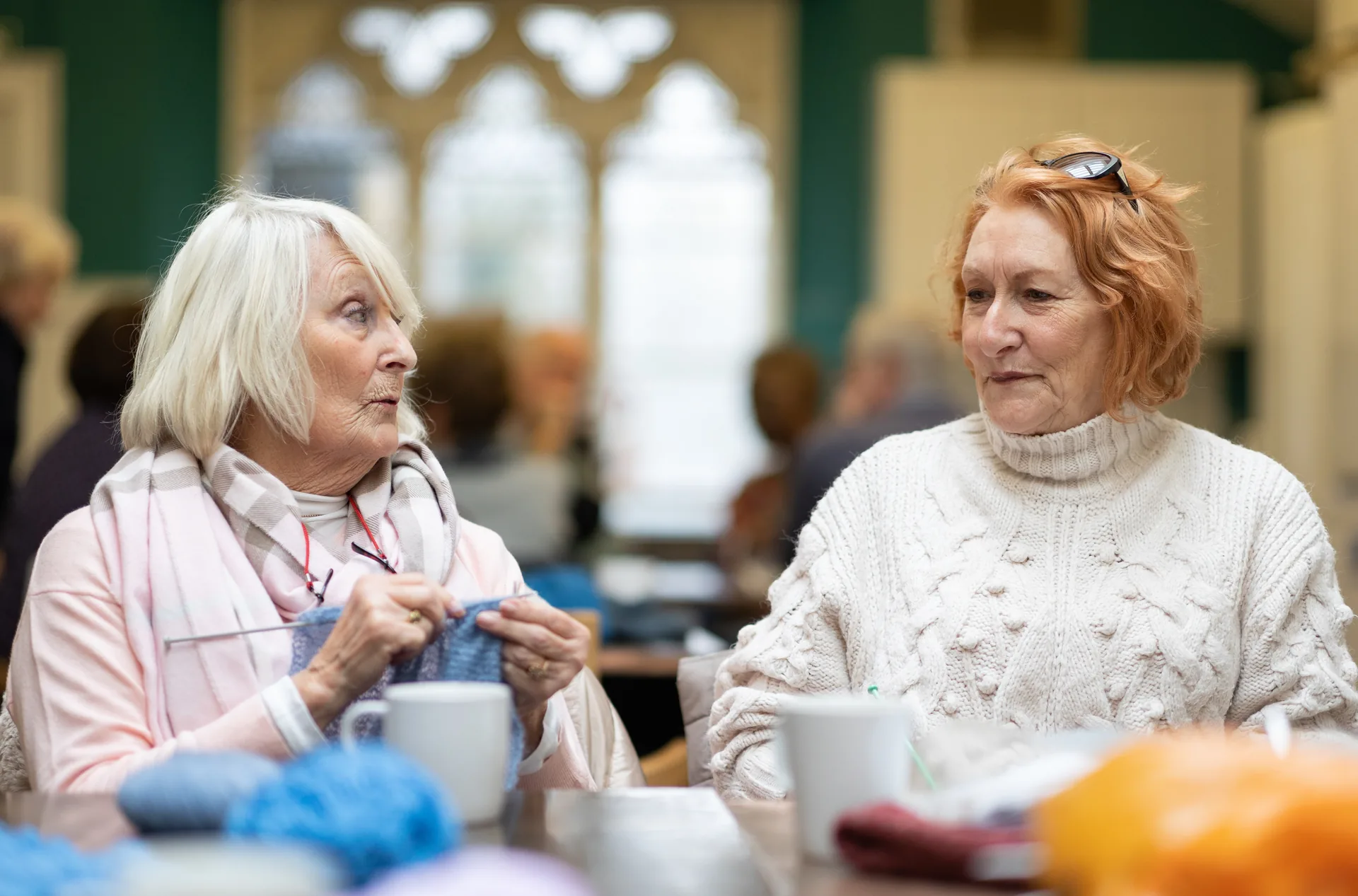 A friendly caregiver interacting warmly with an older woman